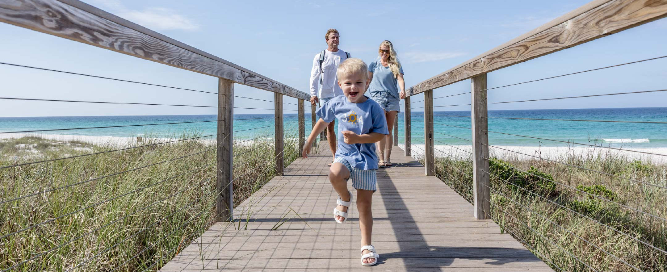 Family walking up from Inlet Beach in 30A gear