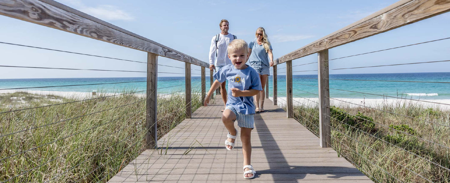Family walking up from Inlet Beach in 30A gear
